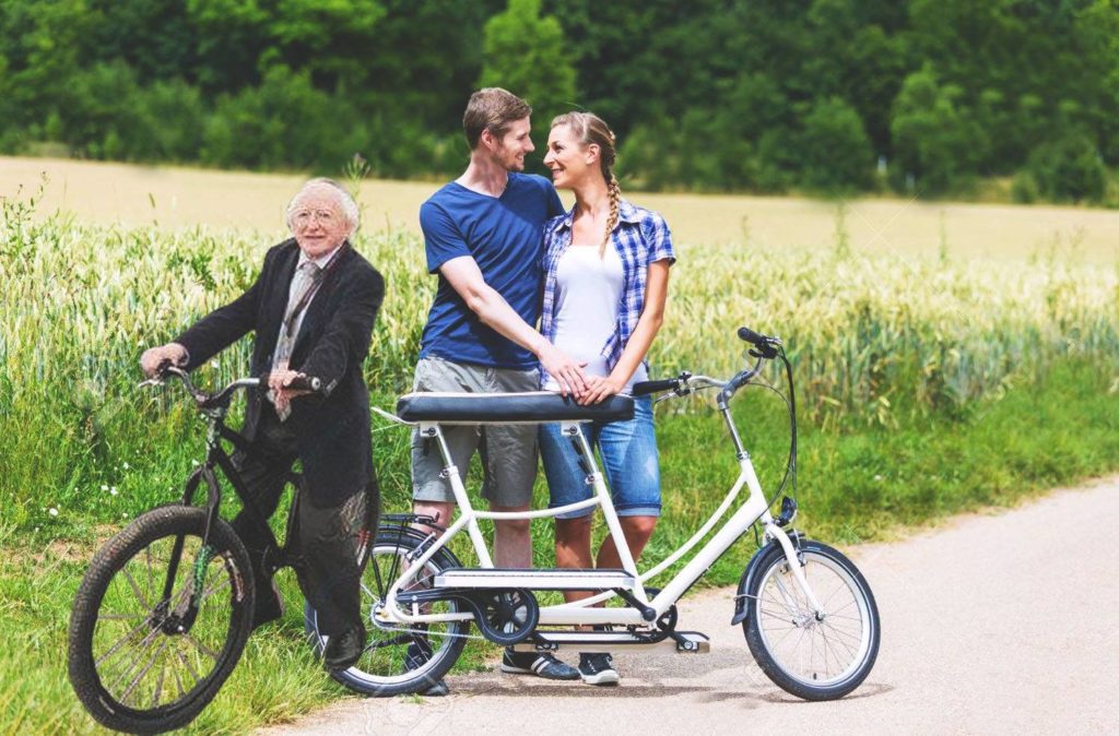 couple and michael d higgins in the park with their bikes